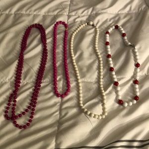 All four necklaces for $20. All are plastic.